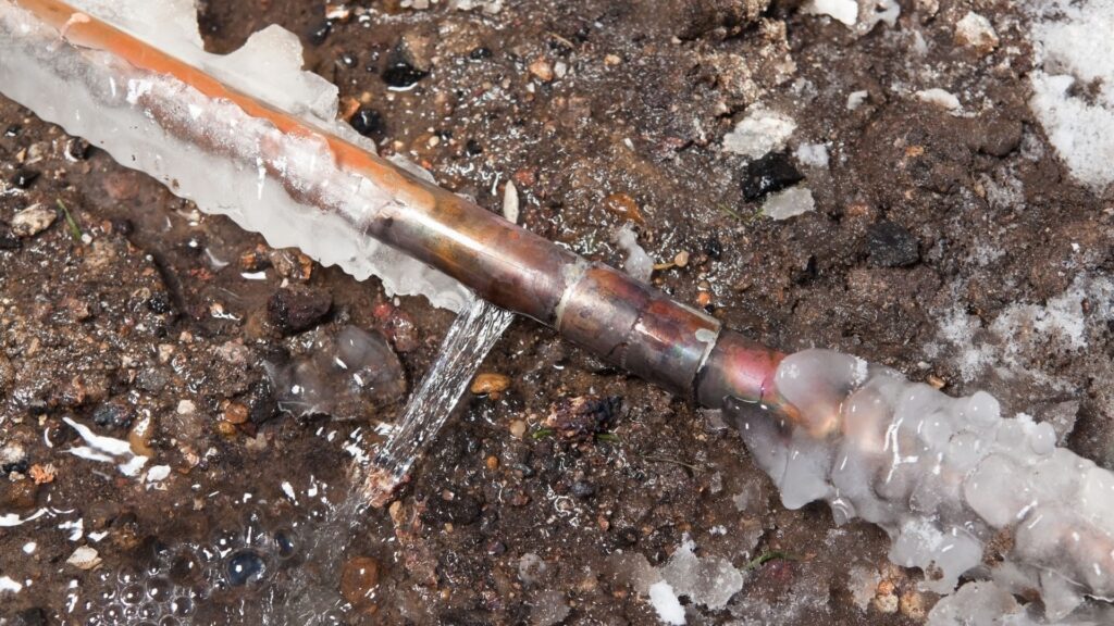Frozen copper pipe on the ground
